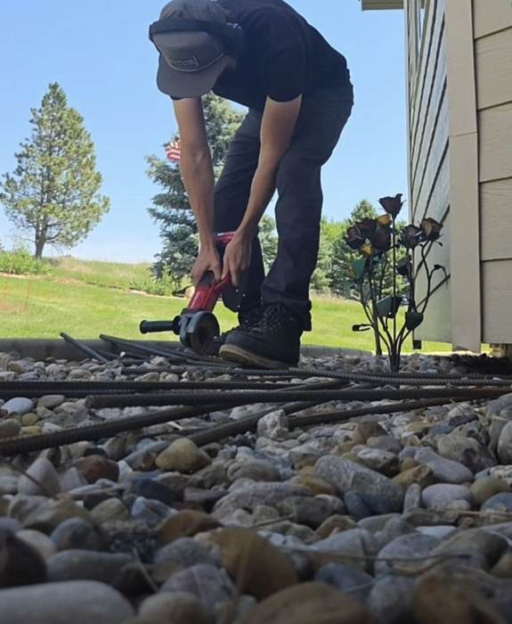 Blade cutting rebar on site for a hardscape base in Rapid City SD